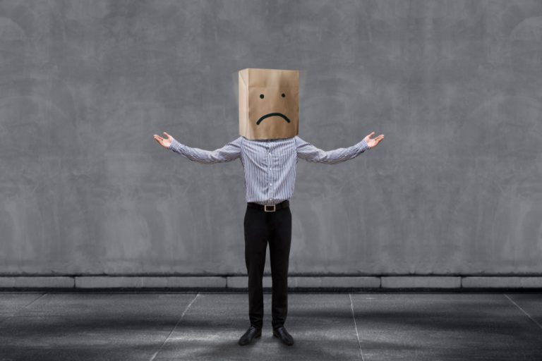 Unhappy Businessman with bag on head