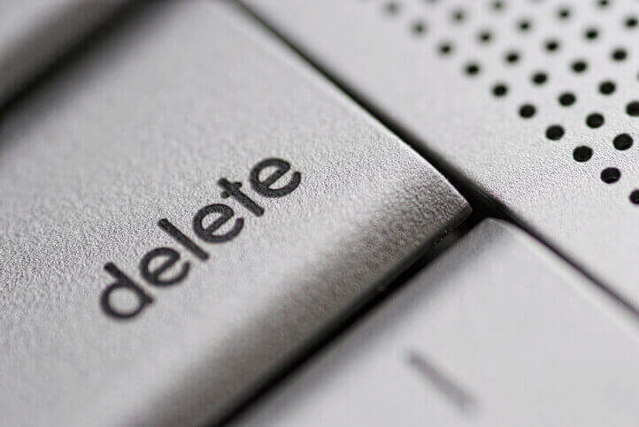 a close up of a computer keyboard with the word delete on it.
