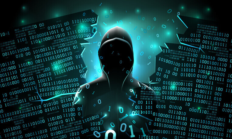 a hooded person in front of a digital background.